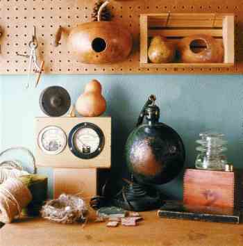 
A workbench with natural and discarded items invites playful creativity—perhaps a parody of the house itself.

